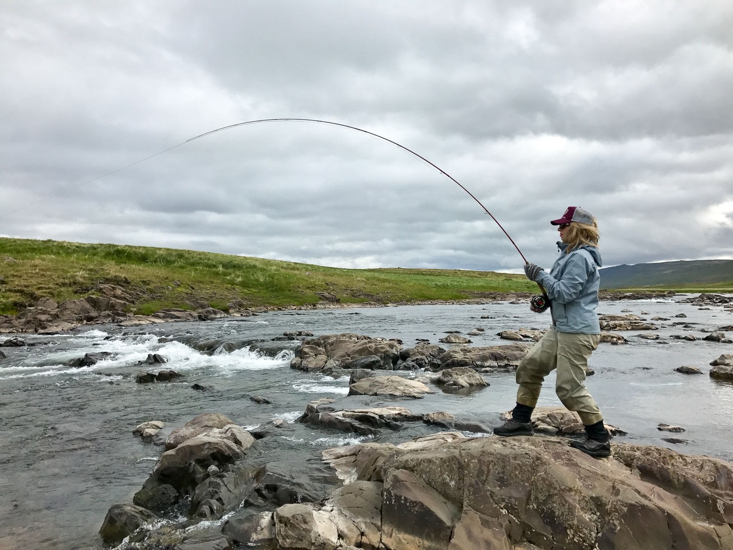 Casting a line into the calm waters of Laxa in Dolum