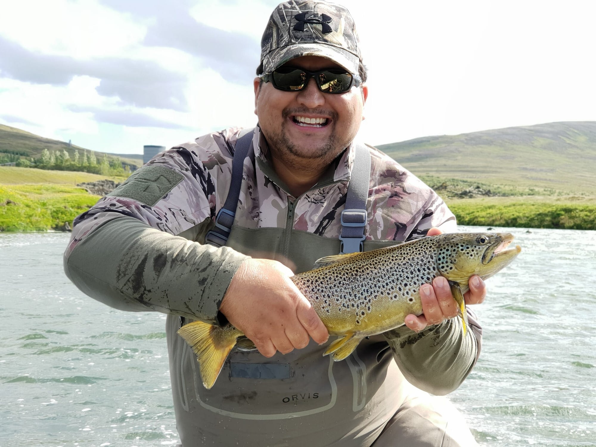 This guide is enjoying the sunny Akureyeri weather while posing with the catch of the day!